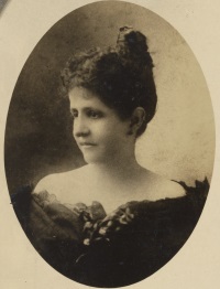 Studio photograph of a white woman wearing late 19th century attire.