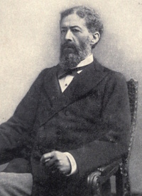 Seated African American man with a beard and mustache wearing late 19th century attire.