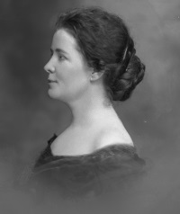 Side view photograph of a white woman wearing late 19th century attire.