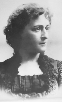 Headshot of a white woman wearing late 19th century attire.