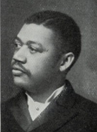 African American man with a mustache wearing late 19th century attire.