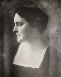 Side view photograph of a white woman wearing late 19th century attire.