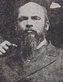 Cropped photograph of an African American man with a beard and mustache wearing late 19th century attire.