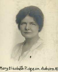 Headshot of a white woman wearing early 20th century attire.