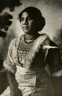 Studio photograph of an African American woman wearing early 20th century attire.
