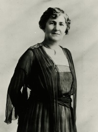 Studio photograph of a white woman wearing early 20th century attire.