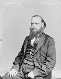 Studio photograph of a seated white man with a beard wearing mid-19th century attire.