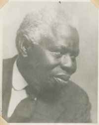 Headshot of an African American man wearing early 20th century attire.