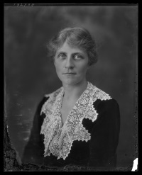 Studio photograph of a white woman wearing early 20th century attire.