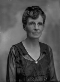 Studio photograph of a white woman wearing early 20th century attire.