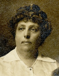 Headshot of a white woman wearing early 20th century attire.