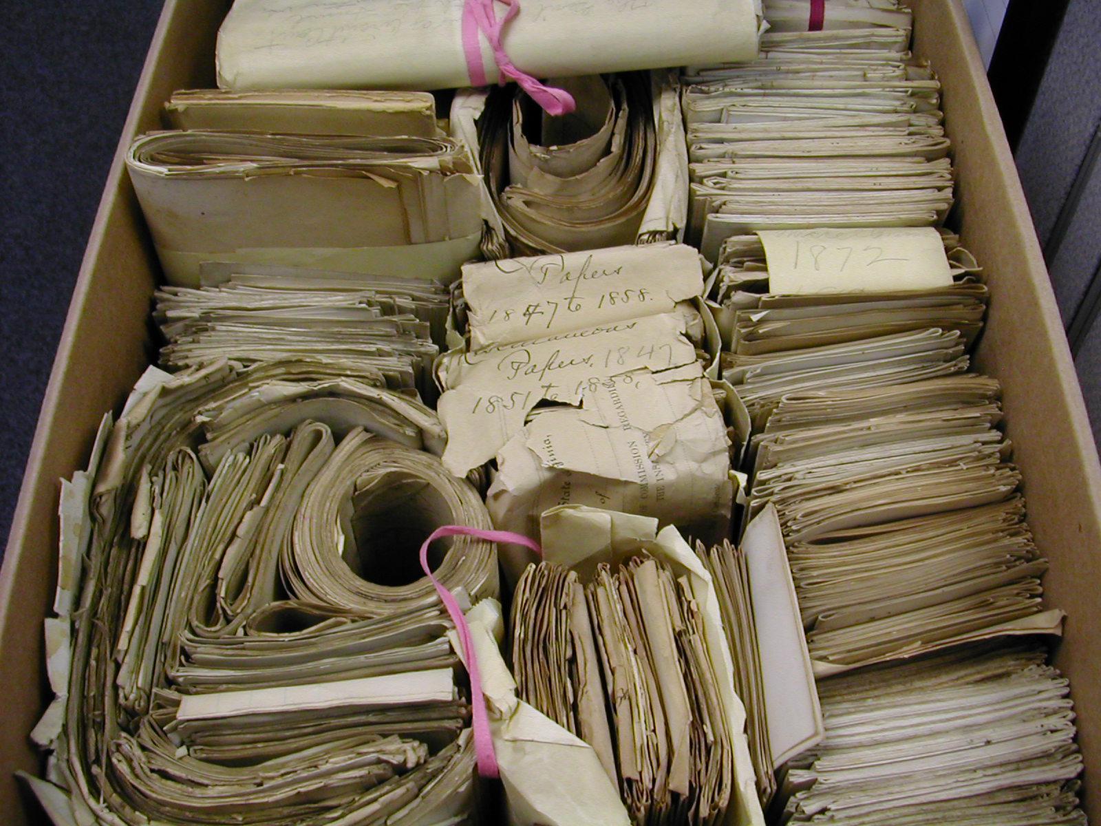 Record center box filed with 19th century documents in there original tri-folded bundles