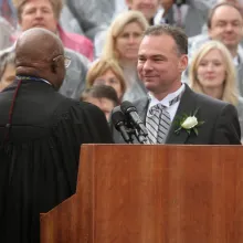 Governor Tim Kaine stands at a podium in a suit to take his oath of office 